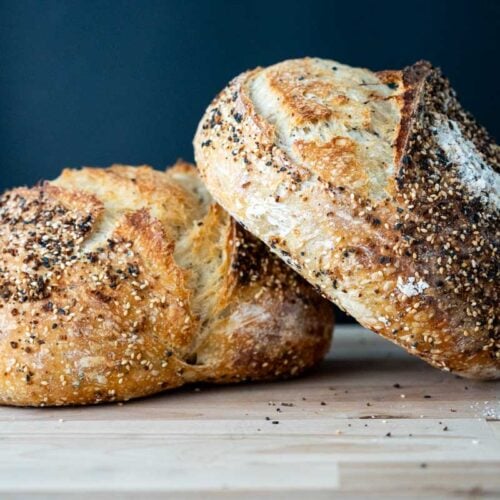 two loaves of sourdough everything bread loaves stacked together