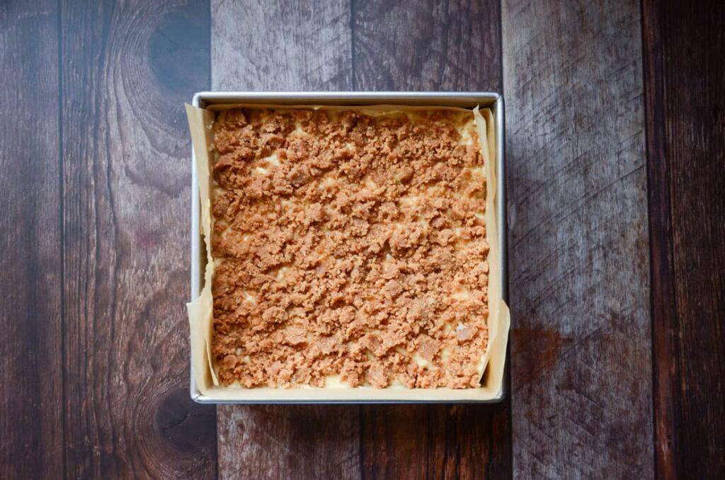 layering the second half of the crumble mixture over the top of the coffee cake