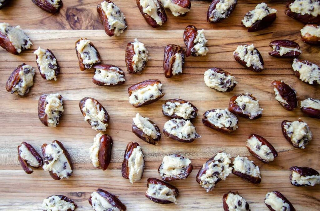 cookie dough stuffed dates on wooden cutting board