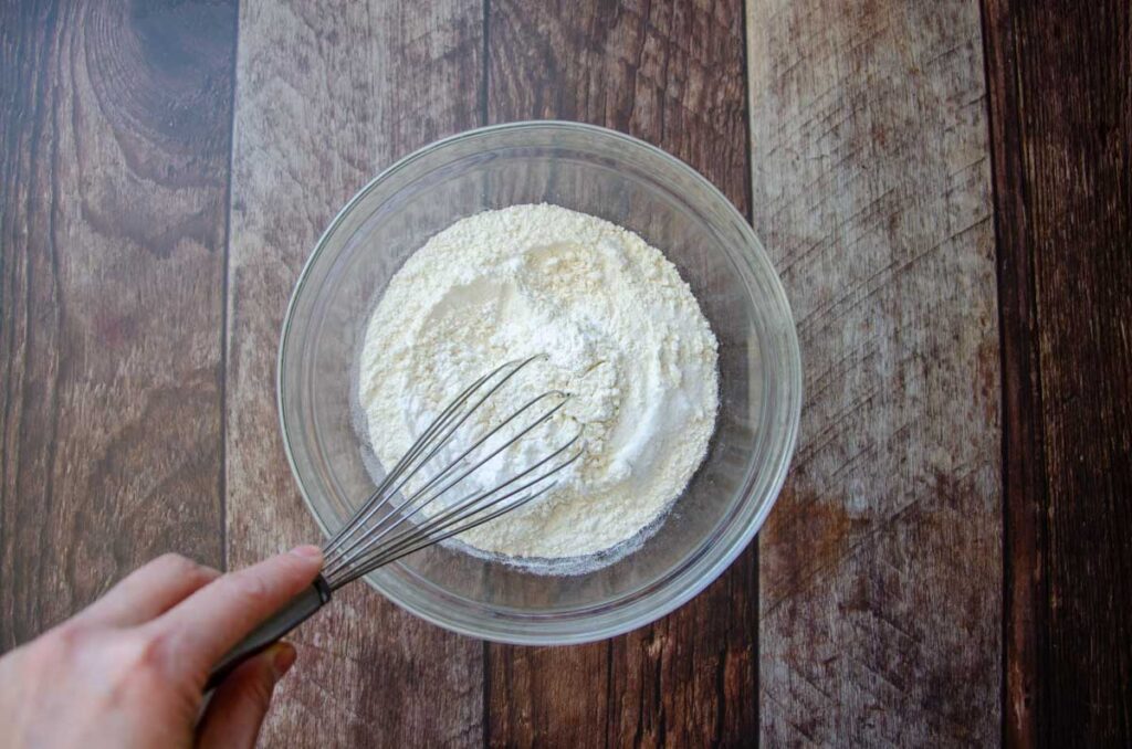 blending the dry ingredients with a  whisk in a glass bowl