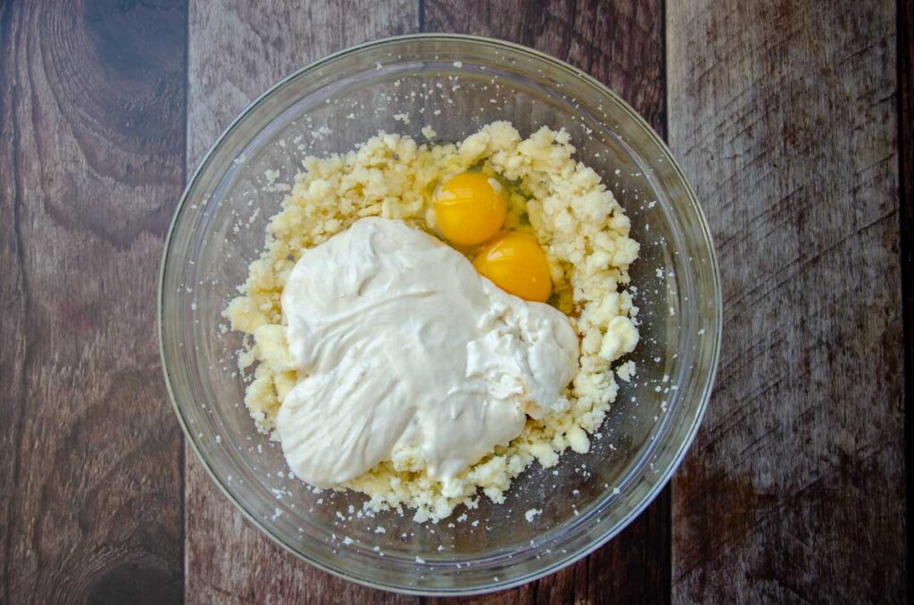 mixing the wet ingredients for sourdough coffee cake in a glass bowl