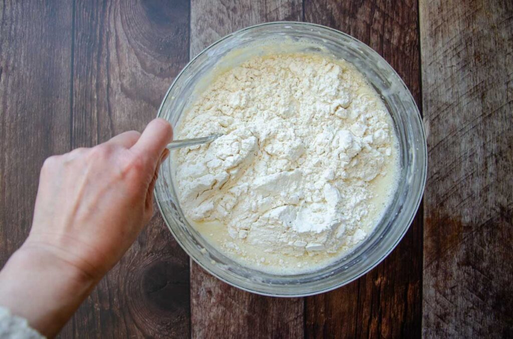 stirring the dry ingredients into the wet ingredients