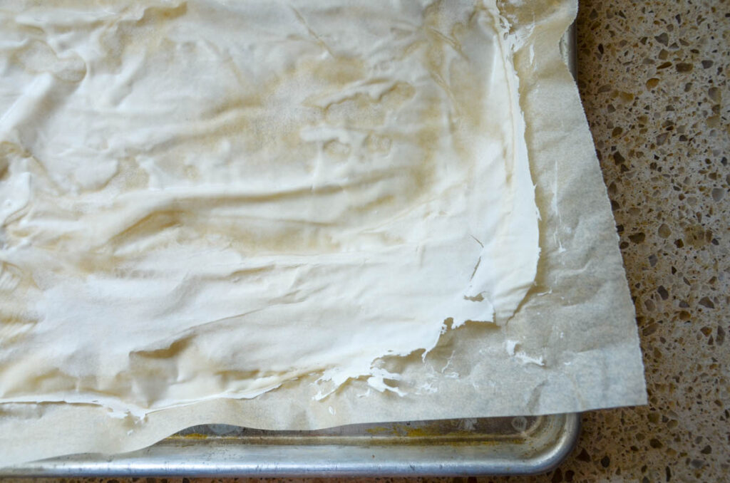 partially dried sourdough starter on parchment paper