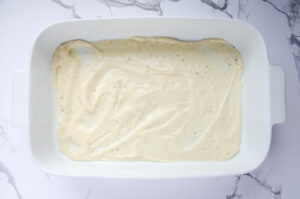 sourdough white sauce in the bottom of a baking dish