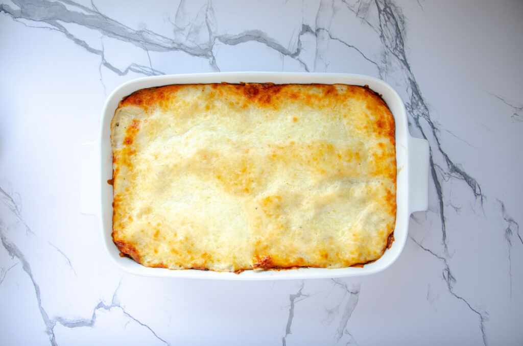 vegetable lasagna in a white baking dish