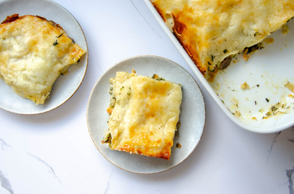 pieces of vegetable lasagna on white plates.