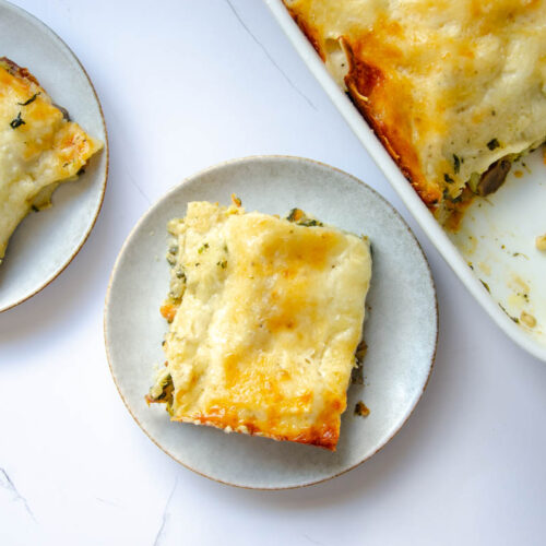 pieces of vegetable lasagna on white plates.