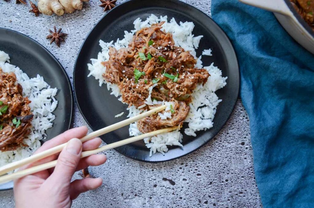 Korean pork and rice eaten with a pair of chop sticks