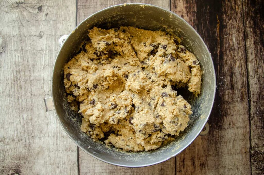 a metal bowl of sourdough chocolate chip oatmeal cookie dough