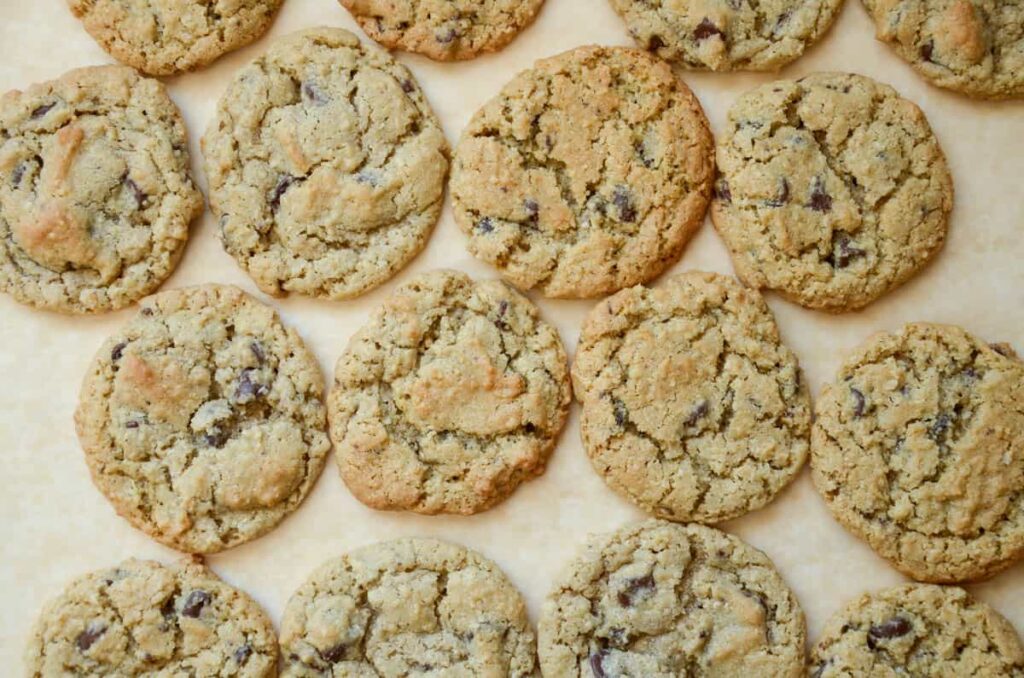 sourdough oatmeal chocolate chip cookies on a piece of parchment paper