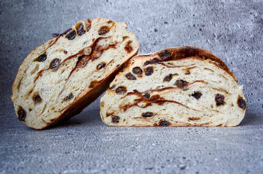 a cut loaf of cinnamon raisin sourdough bread