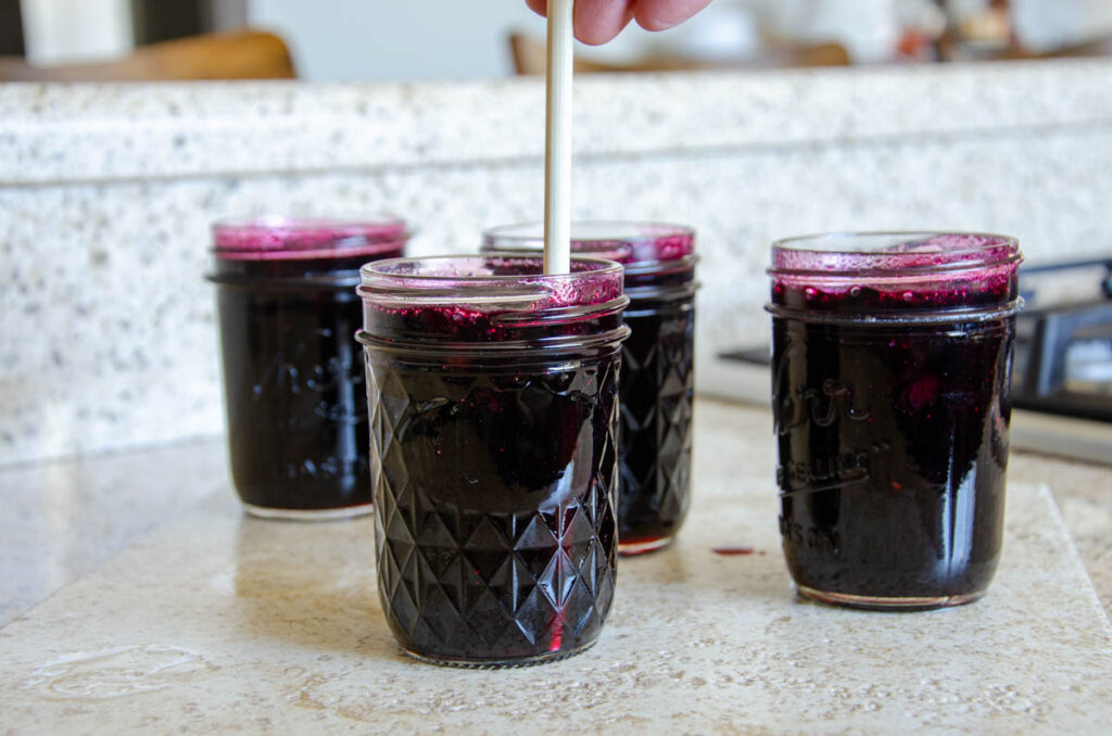 removing the air bubbles in a glass jar using a chop stick