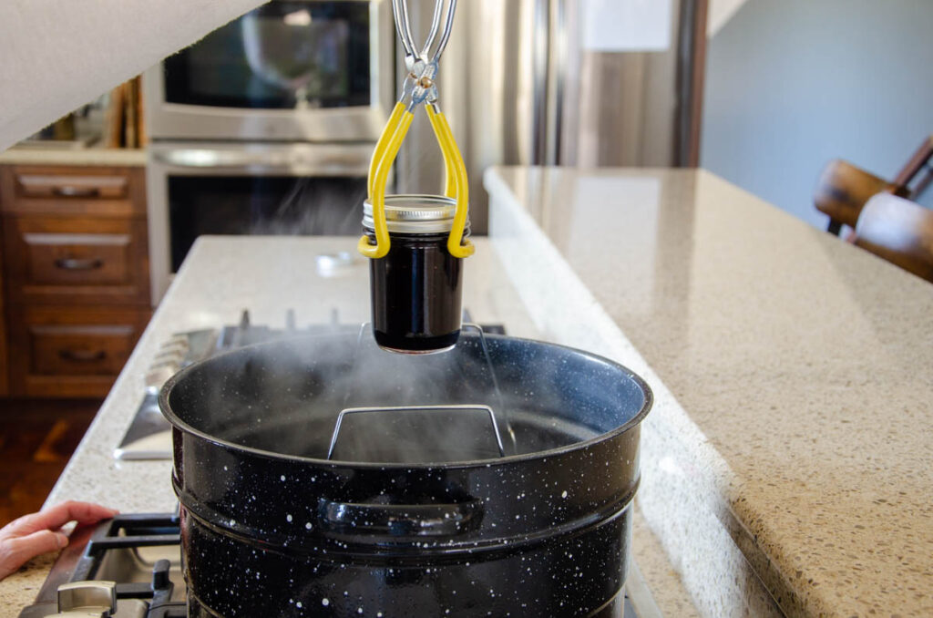lifting a jar into a water bath canner