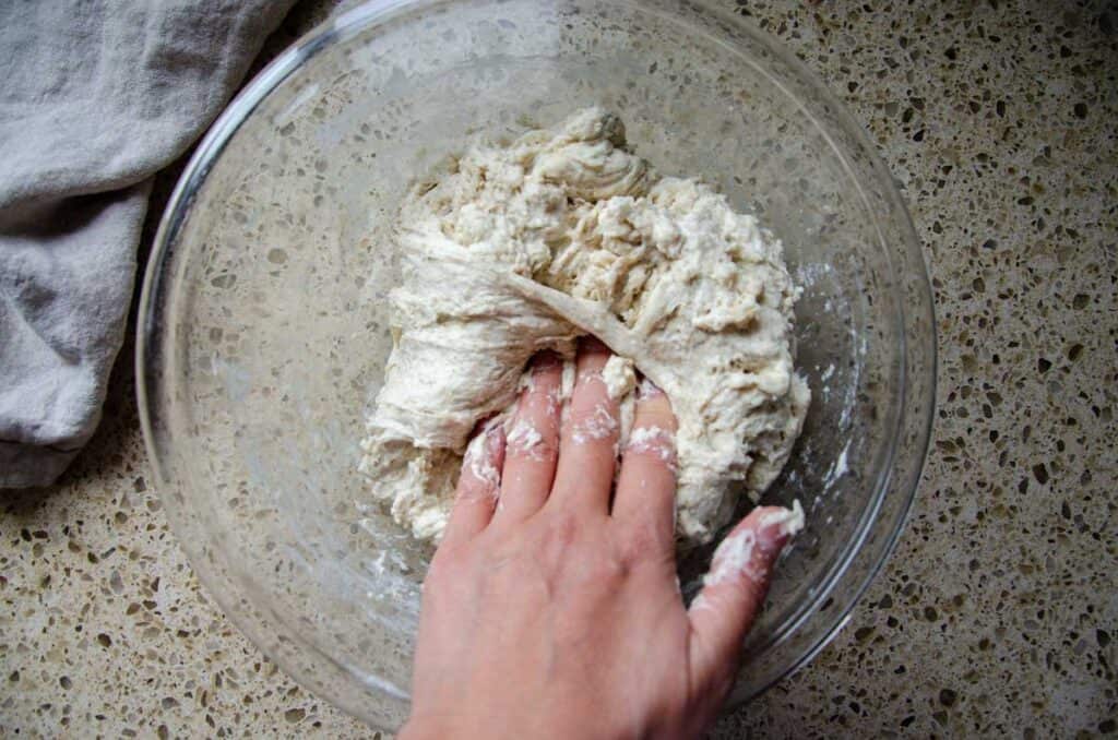 folding the sourdough pesto sun dried tomato bread dough