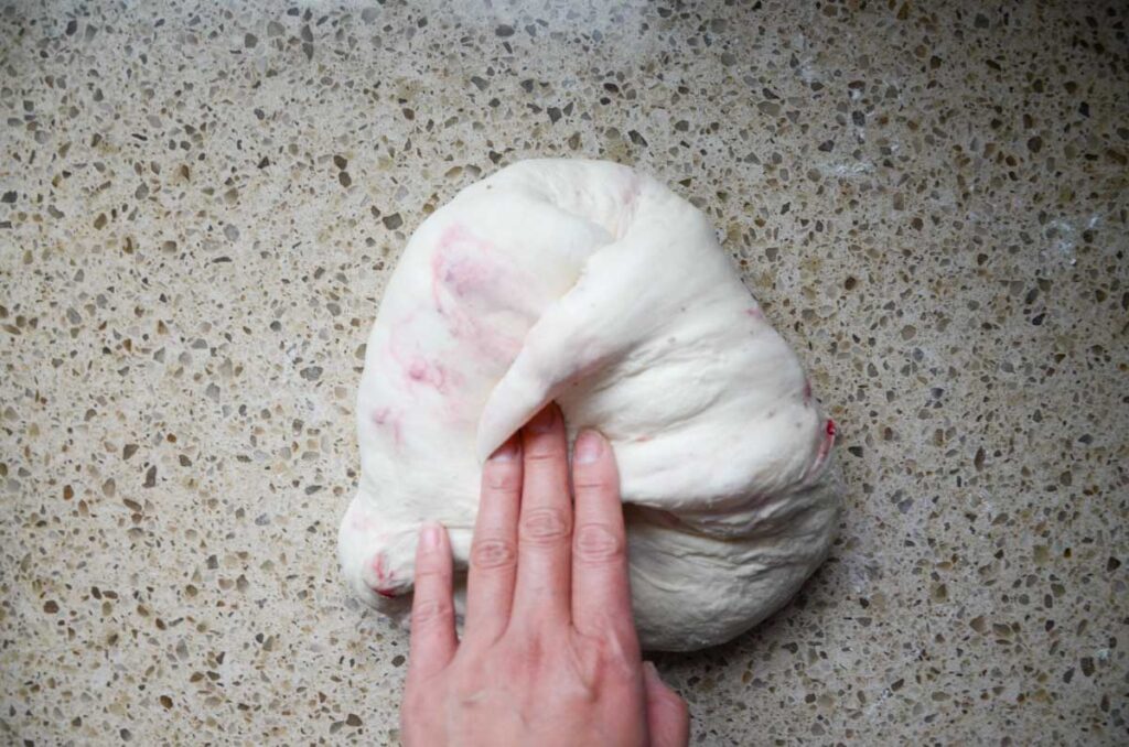 folding the side of sourdough dough over to the middle