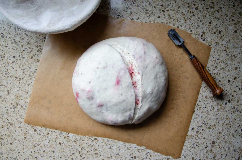 strawberry sourdough bread dough on a piece of parchment paper