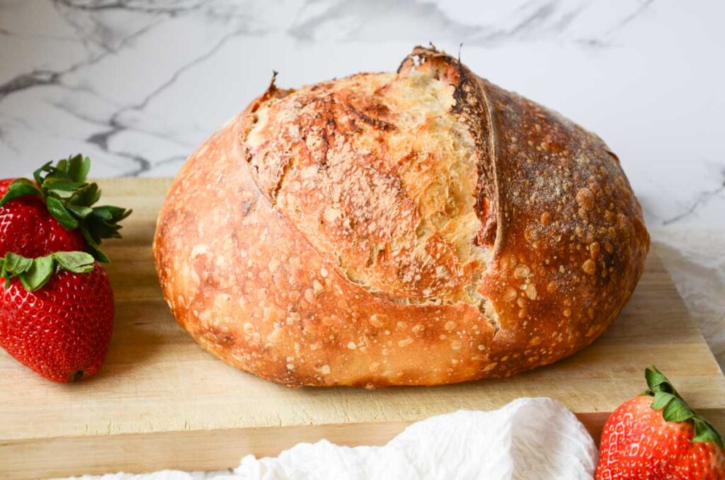 strawberry sourdough bread on a wood cutting board