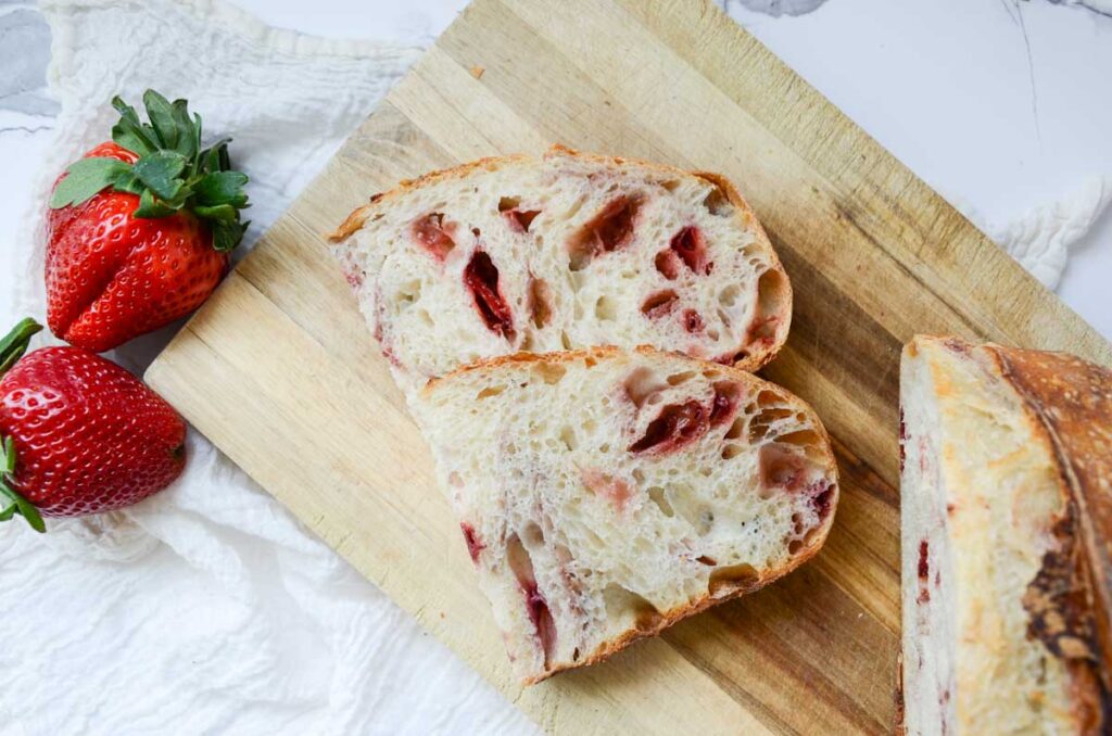 slices of strawberry sourdough bread on wood cutting board