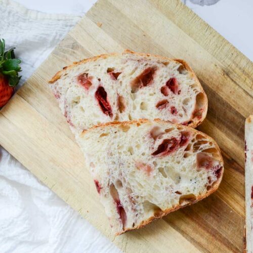 slices of strawberry sourdough bread on wood cutting board