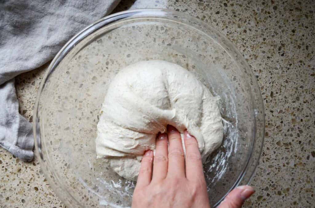 folding the smooth sourdough pesto sun dried tomato bread dough