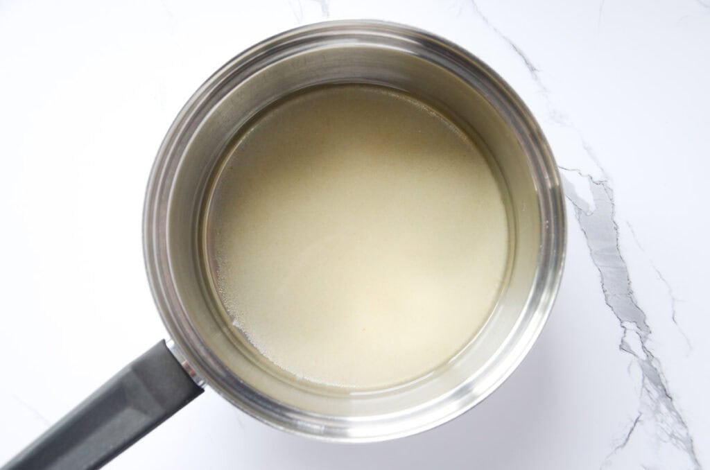making simple syrup with water and sugar in a saucepan
