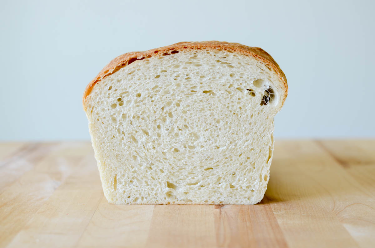 a side voew of a cut loaf of sourdough sandwich bread