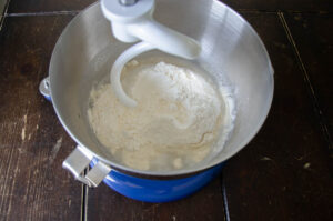 sourdough sandwich bread ingredients in the bowl of a stand mixer