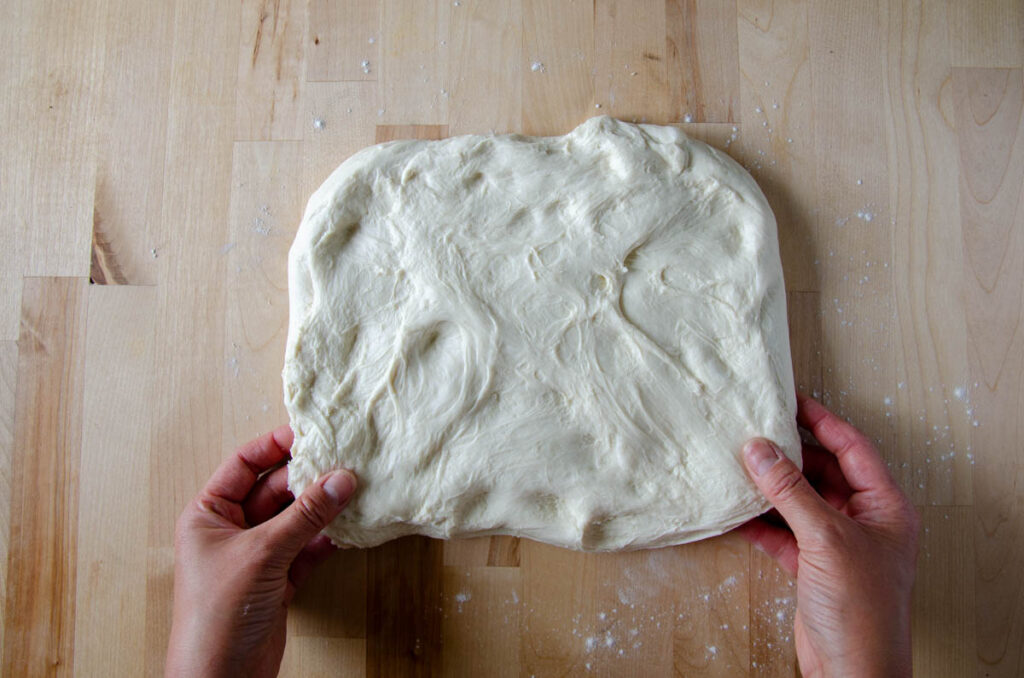 stretching the dough out into a rectangle