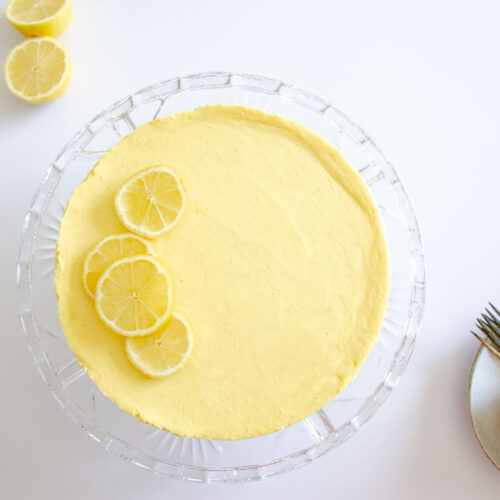 lemon cheesecake on a glass pedestal stand