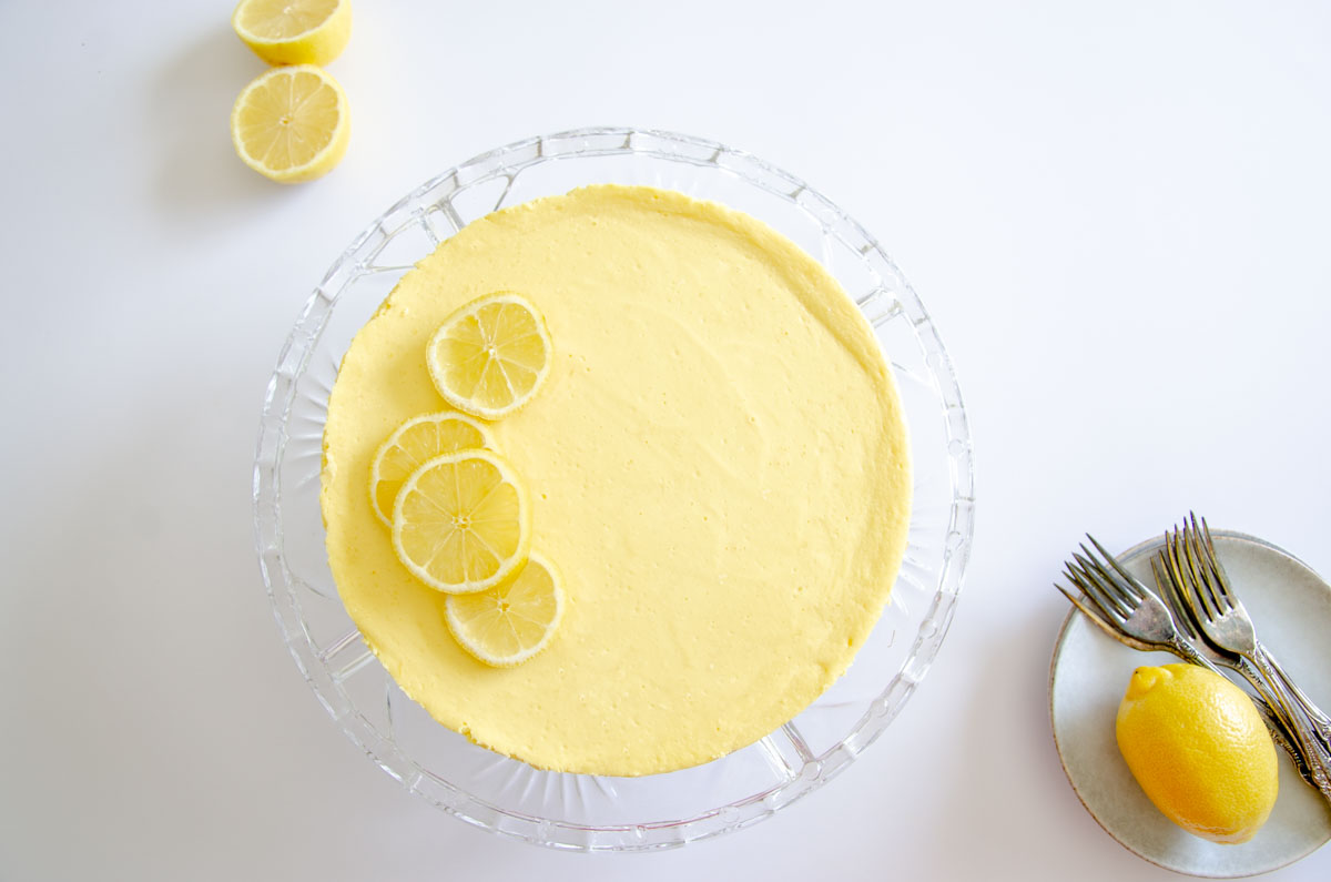 lemon cheesecake on a glass pedestal stand