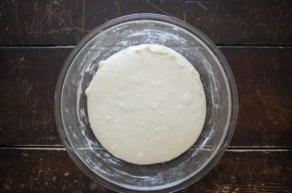 Expanded dough in glass bowl