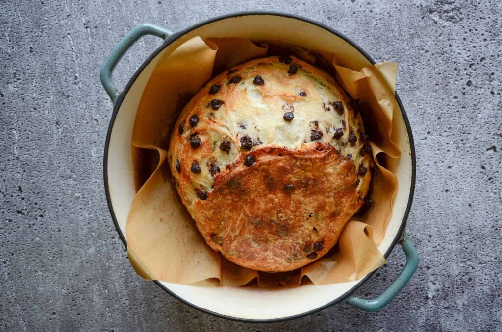 sourdough chocolate chip croissant bread in blue dutch oven