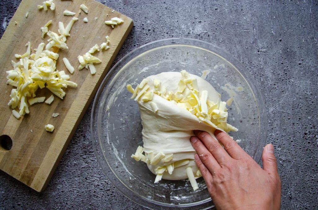 Butter folded by hand into sourdough chocolate chip croissant dough