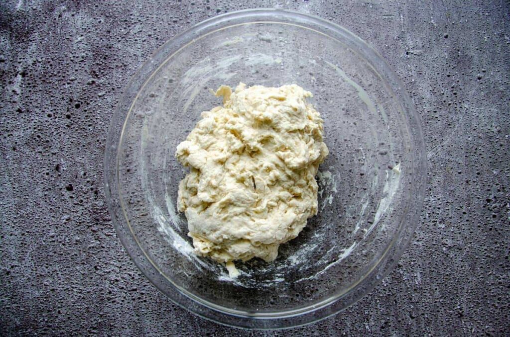 Combined dough in glass bowl on slate 
