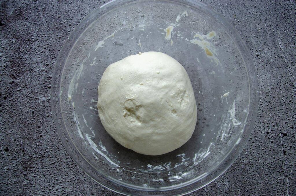 Dough in ball in glass bowl