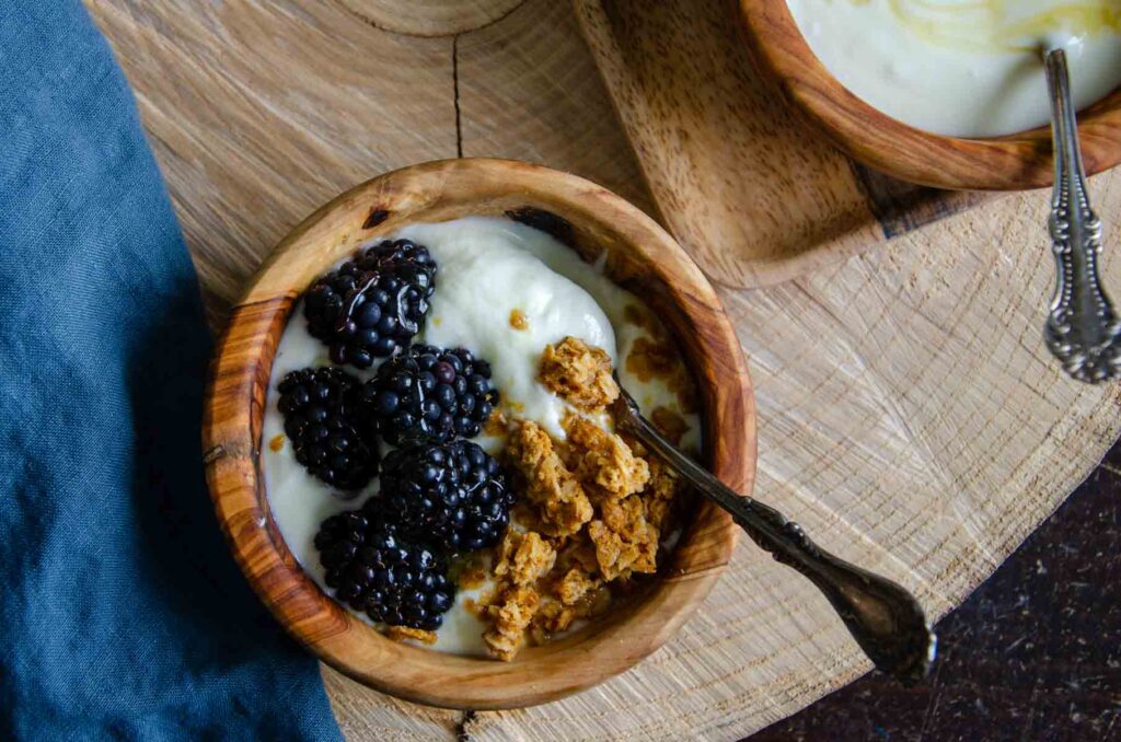 Blackberries and granola in a bowl of homemade Greek yogurt