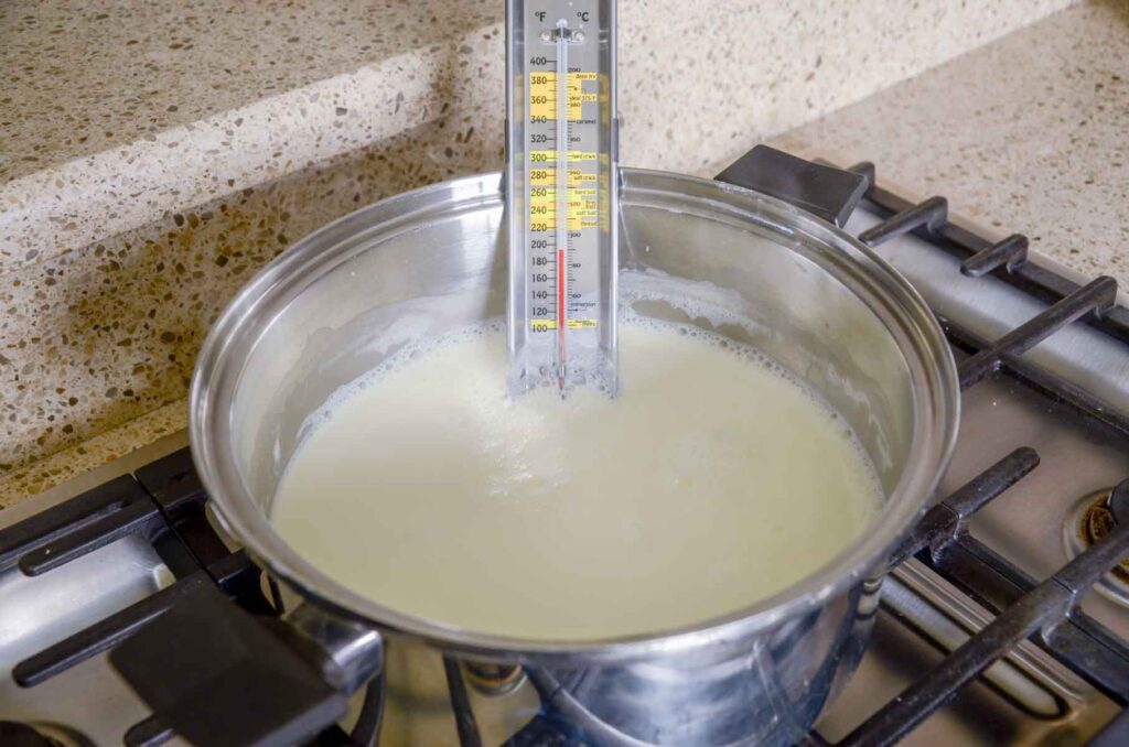 heating milk in a pot to make homemade Greek yogurt