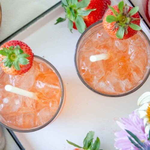 two glasses of strawberry shrub on a white tray