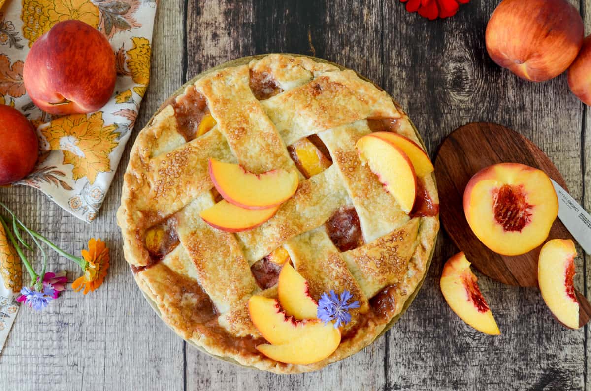peach pie with whole peaches and peach slices
