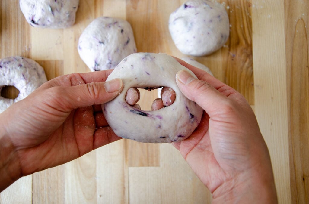 stretching dough into a bagel shape