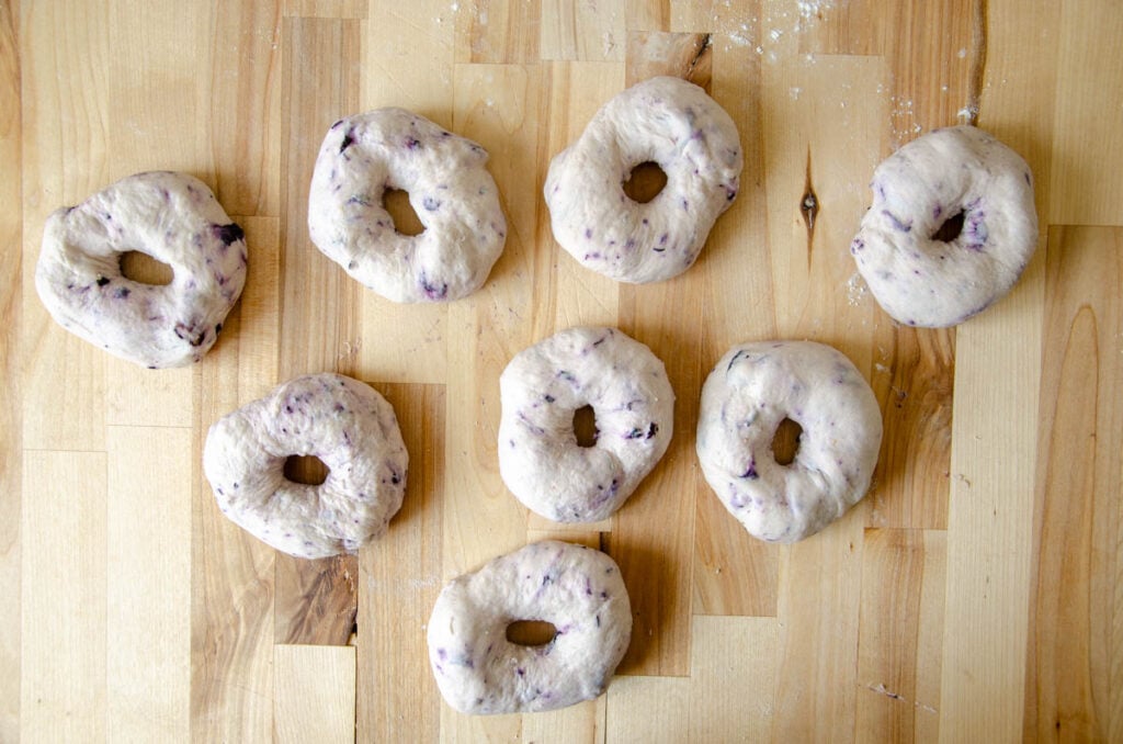 shaped bagels on a parchment lined baking sheet