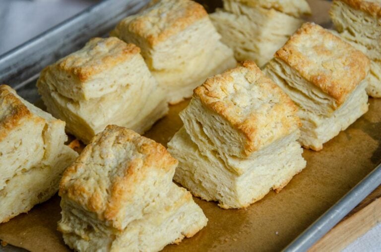 sourdough buttermilk biscuits on a parchment lined baking sheet