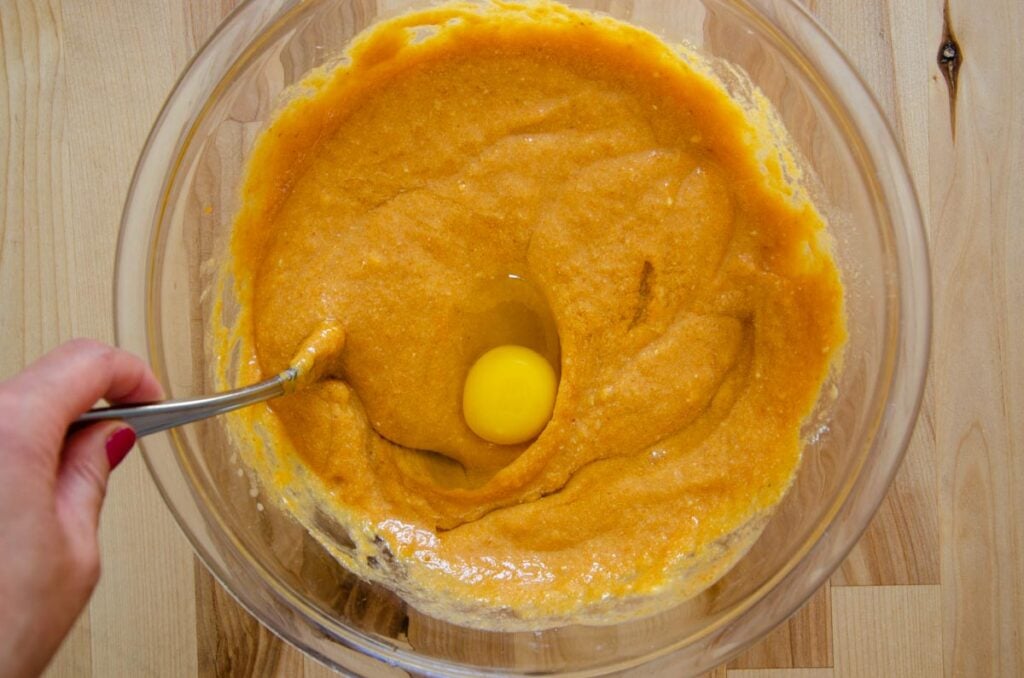 adding an egg to the sourdough pumpkin coffee cake wet ingredients