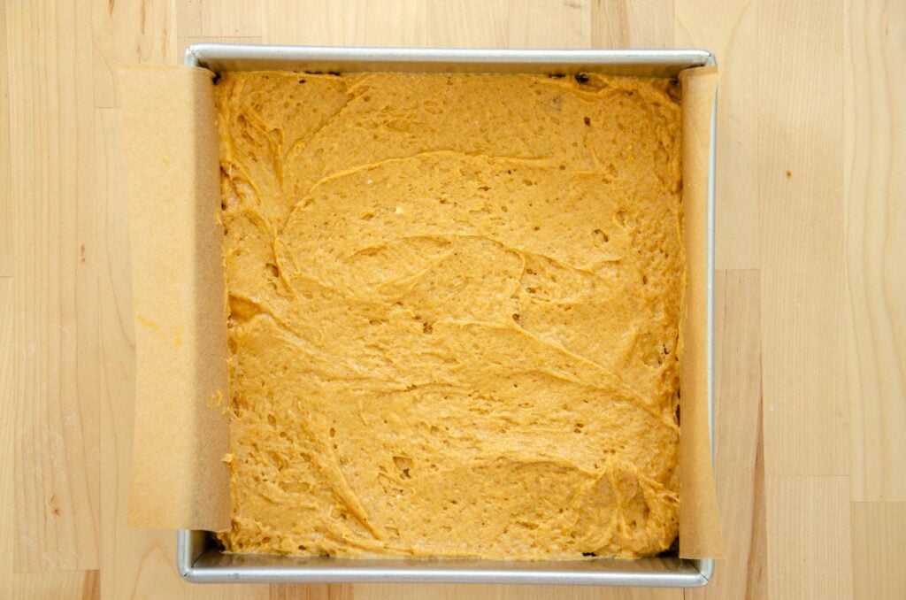 adding more sourdough pumpkin coffee cake batter