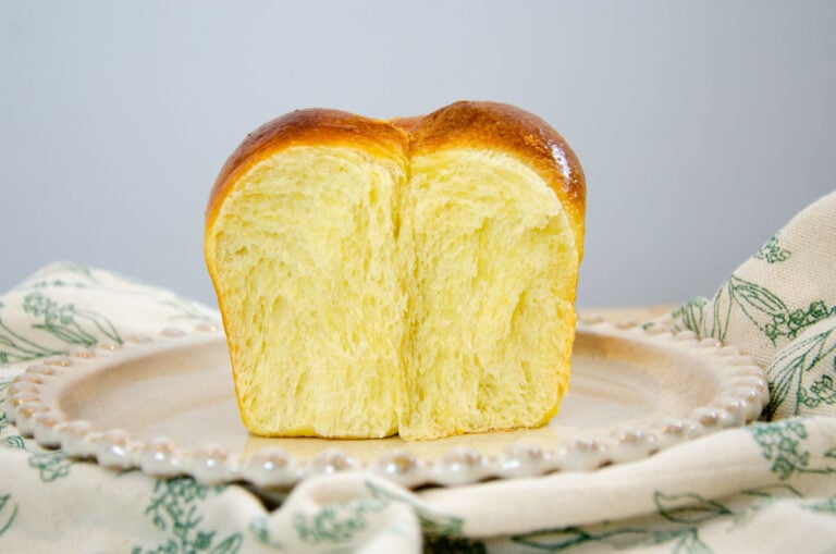 a sideview of a cut sourdough broiche bread loaf