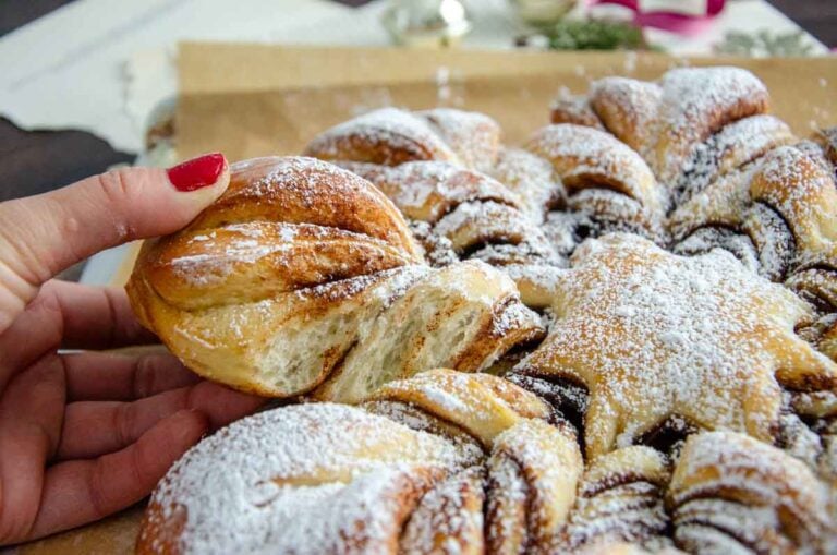 pulling off a piece of sourdough star bread