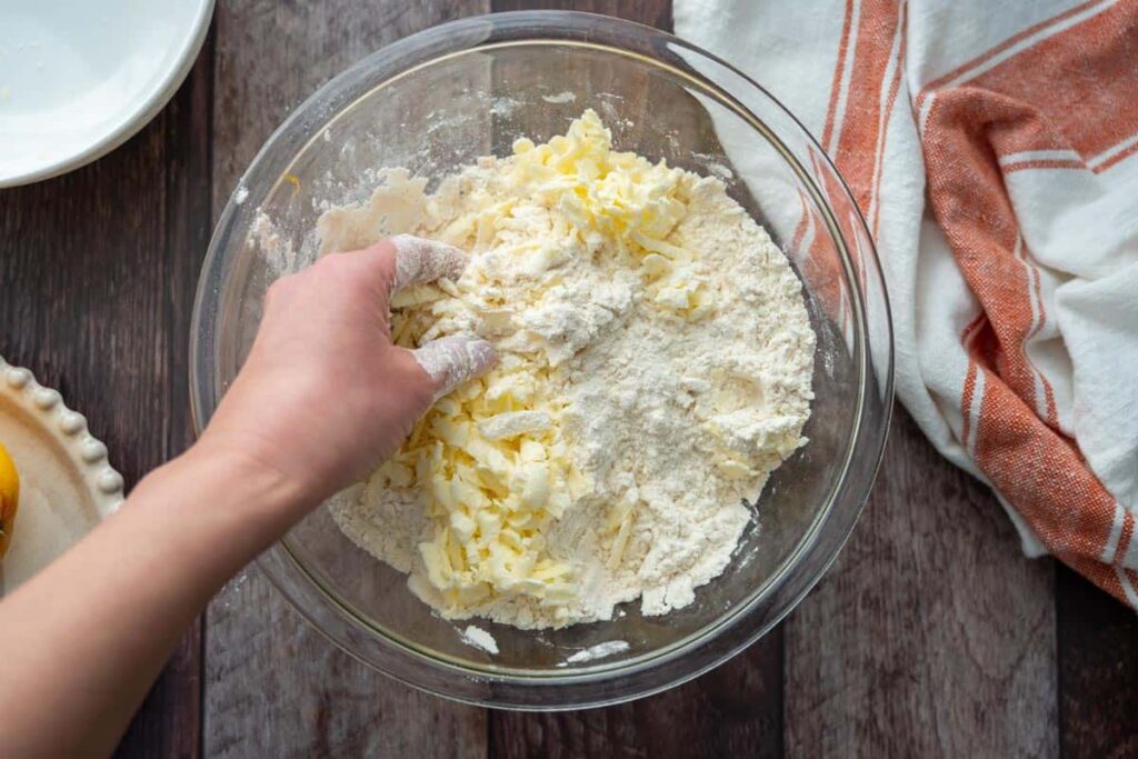 adding butter to dry ingredients