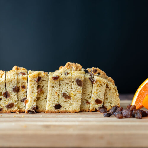 sourdough Irish soda bread slices with orange slices and a small pile of raisins