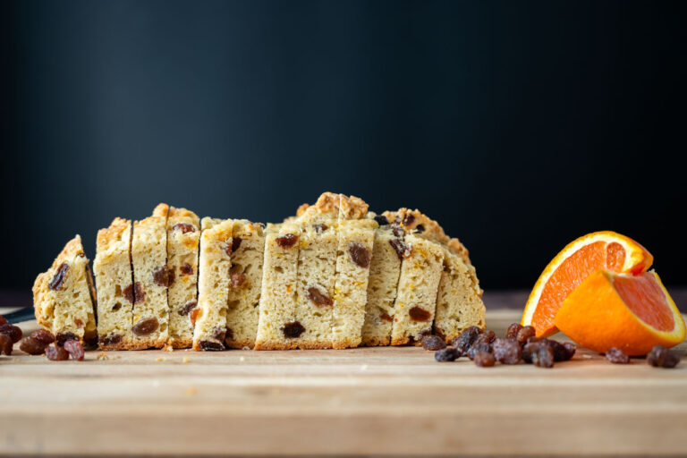 sourdough Irish soda bread slices with orange slices and a small pile of raisins