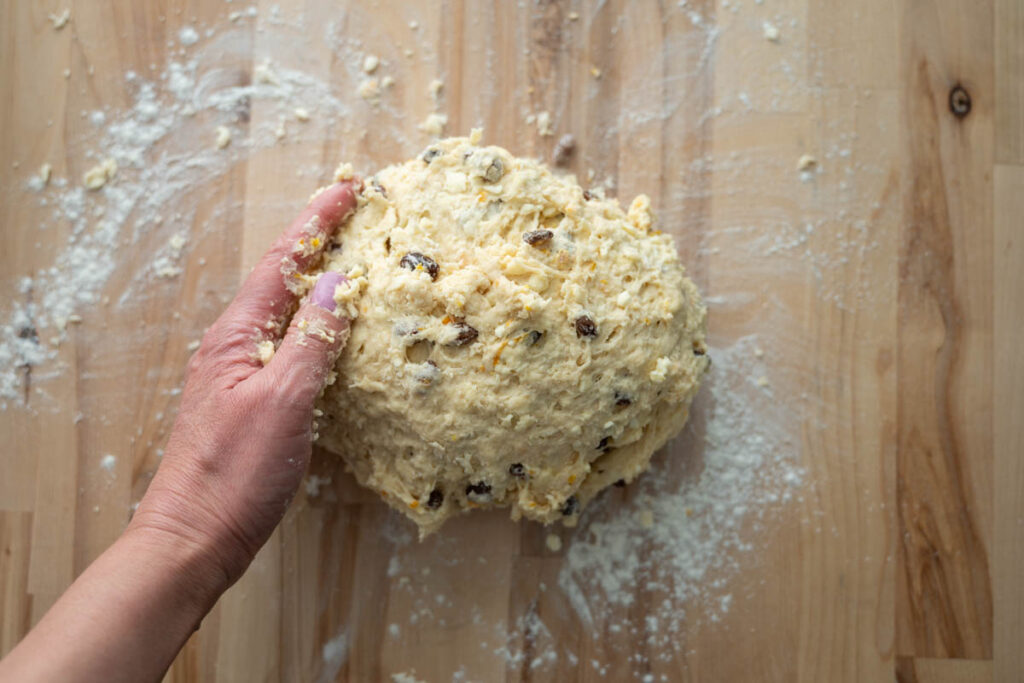 shaping sourdough Irish soda bread on a lightly floured work surface